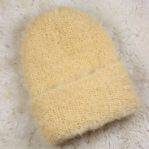 A furry hat with a twist brim