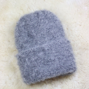 A furry hat with a twist brim