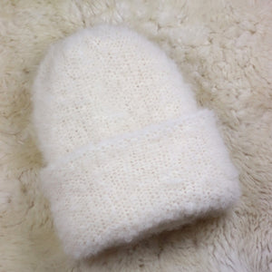 A furry hat with a twist brim