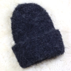 A furry hat with a twist brim